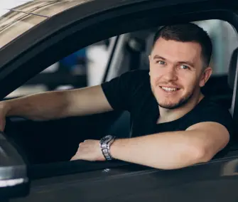 handsome-man-sitting-car-testing-it